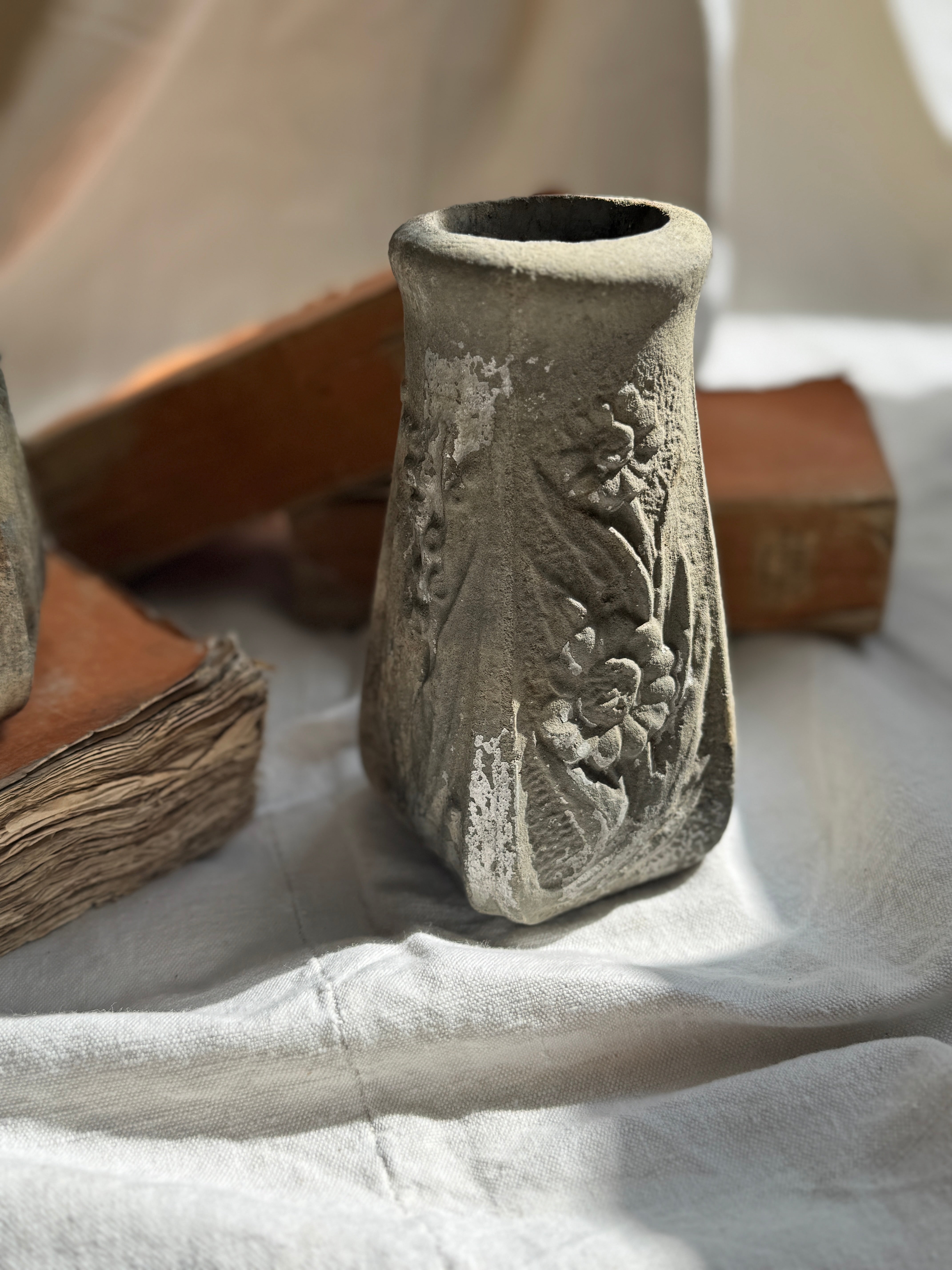 Weathered Cast Stone Vase with Floral Relief